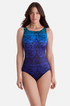 Woman wearing an animal-esque printed one-piece swimsuit in blue