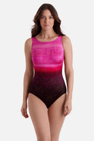 Woman wearing a pink ombre one-piece swimsuit with shimmer detailing
