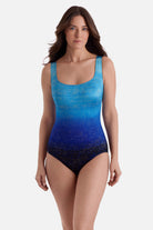 Woman wearing a blue ombre one-piece swimsuit with shimmer detail
