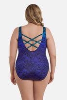 Woman turned away wearing a blue ombre animal-esque printed one-piece swimsuit with an X back