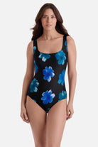 Woman wearing a one-piece swimsuit with large blue flowers