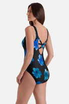 Woman turned left wearing a one-piece swimsuit with large blue flowers