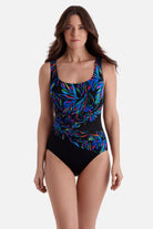 Woman wearing an abstract rainbow print one-piece swimsuit