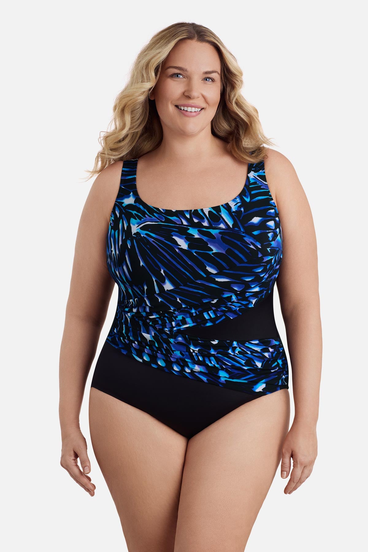 Woman wearing a blue abstract printed one-piece swimsuit with a sash effect