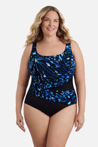 Woman wearing a blue abstract printed one-piece swimsuit with a sash effect