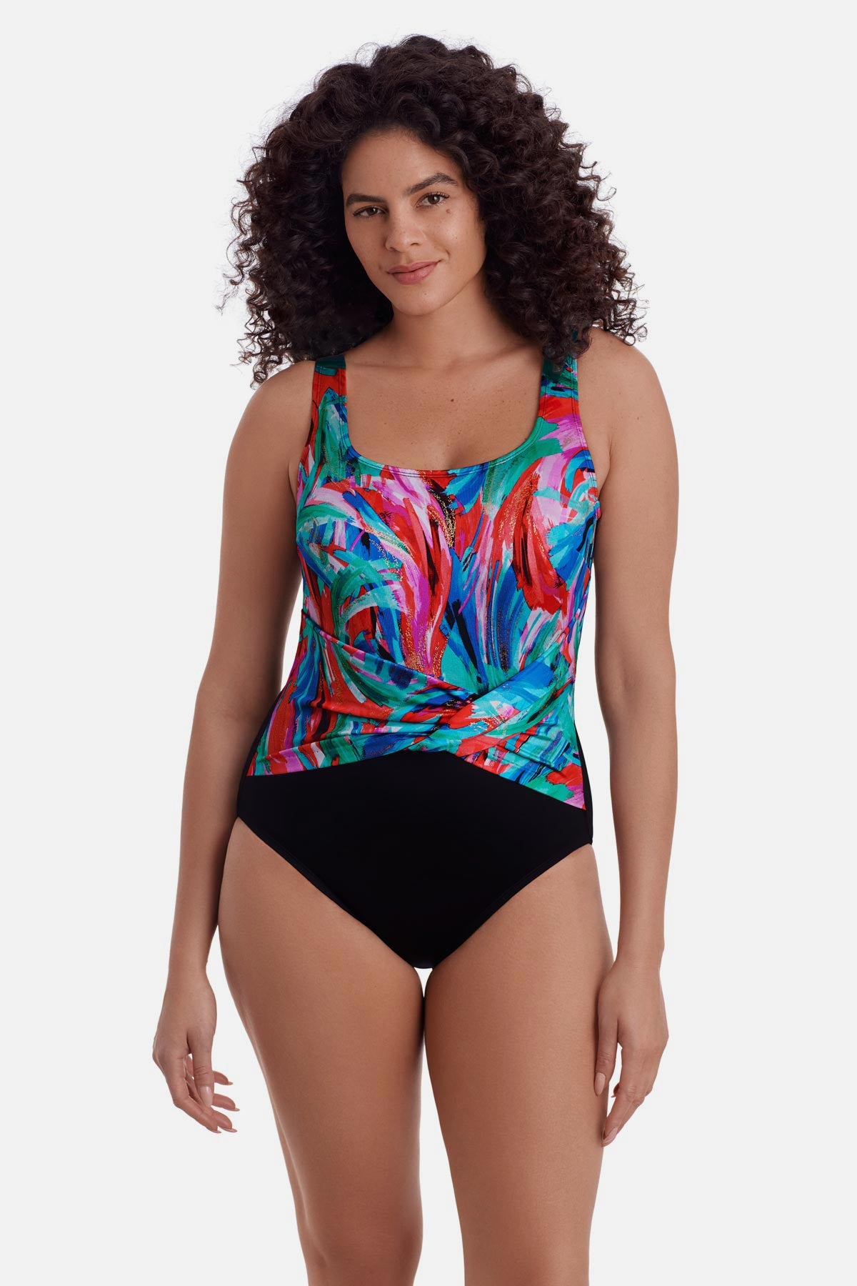 Woman wearing a multicolor abstract printed one-piece swimsuit with a sash detail