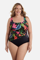 Woman wearing a multicolored floral and palm leaf printed one-piece swimsuit