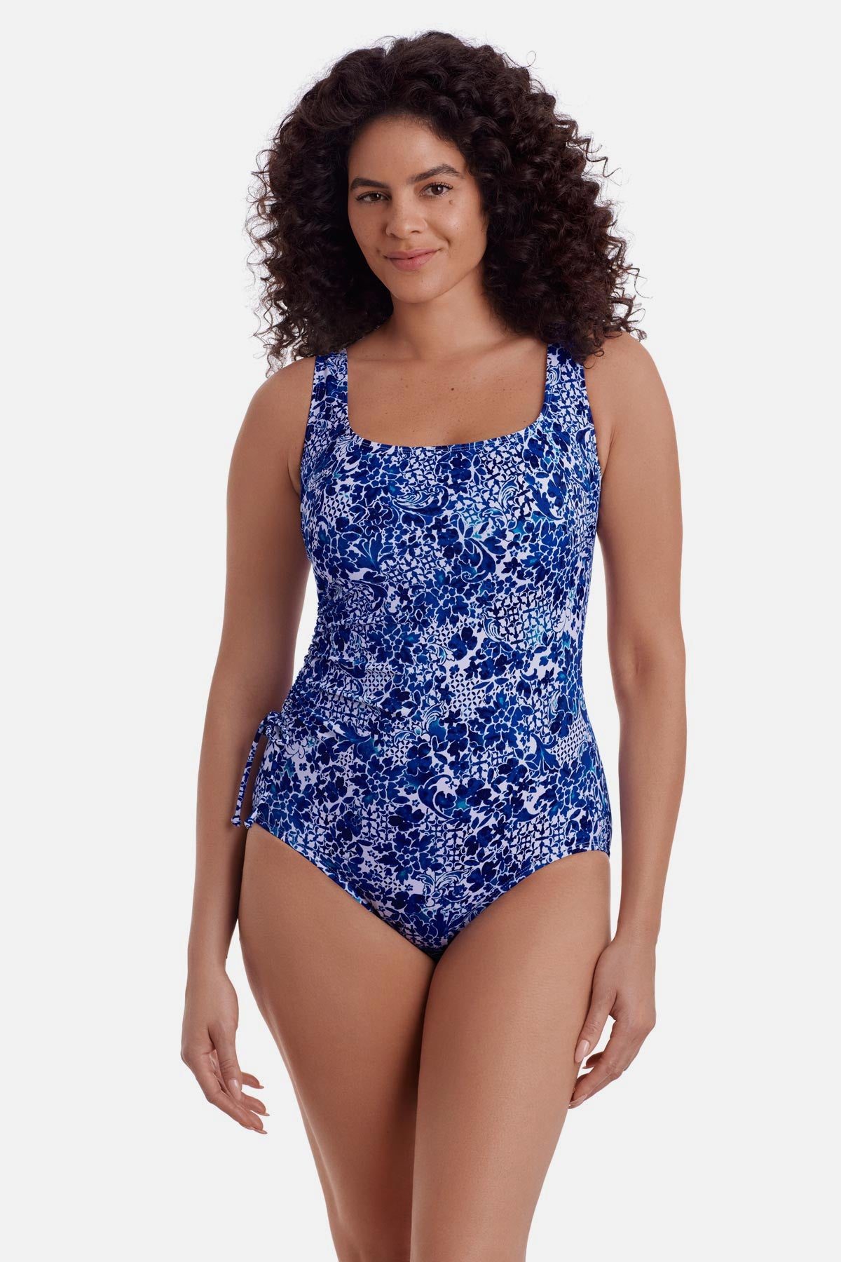 Woman wearing a blue and white floral printed one piece swimsuit