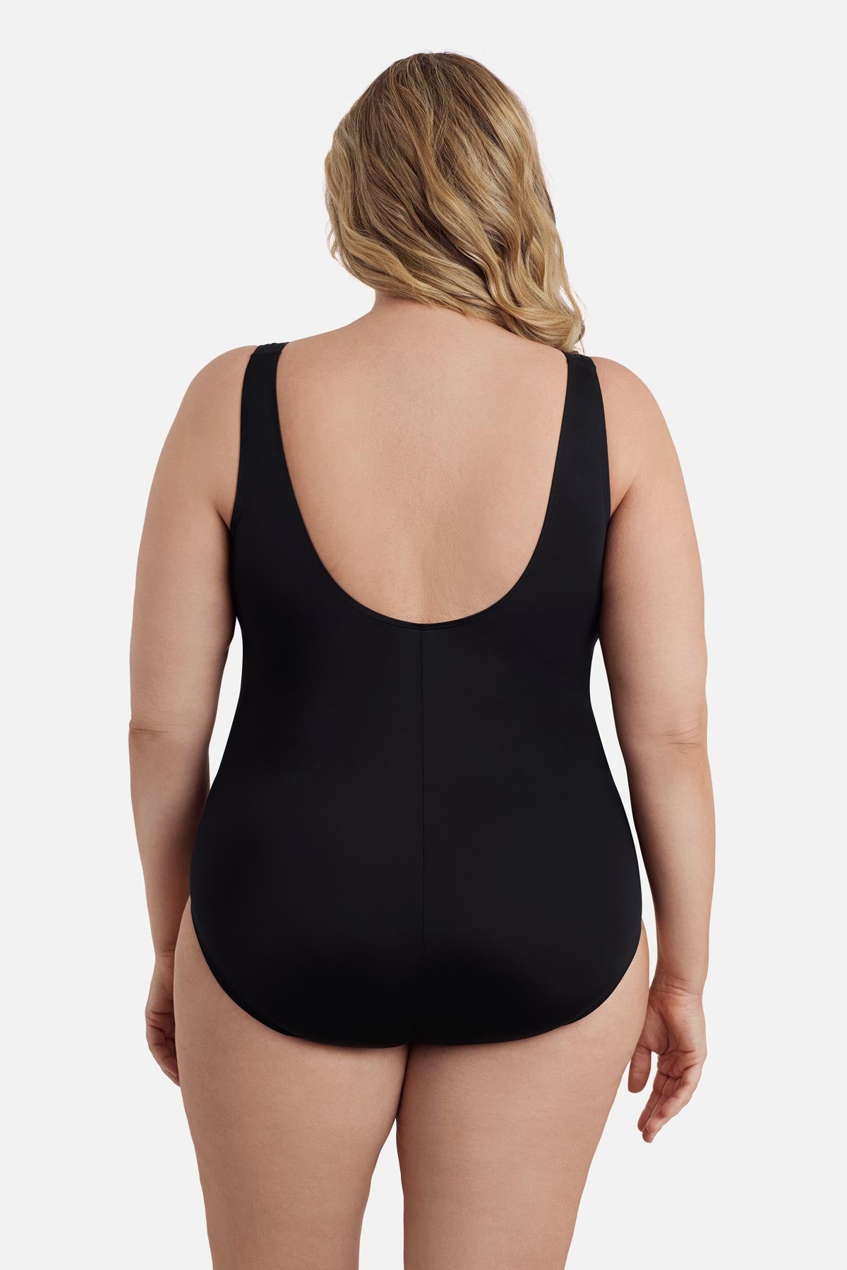 Woman turned away wearing an ombre black one-piece swimsuit