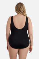 Woman turned away wearing an ombre black one-piece swimsuit