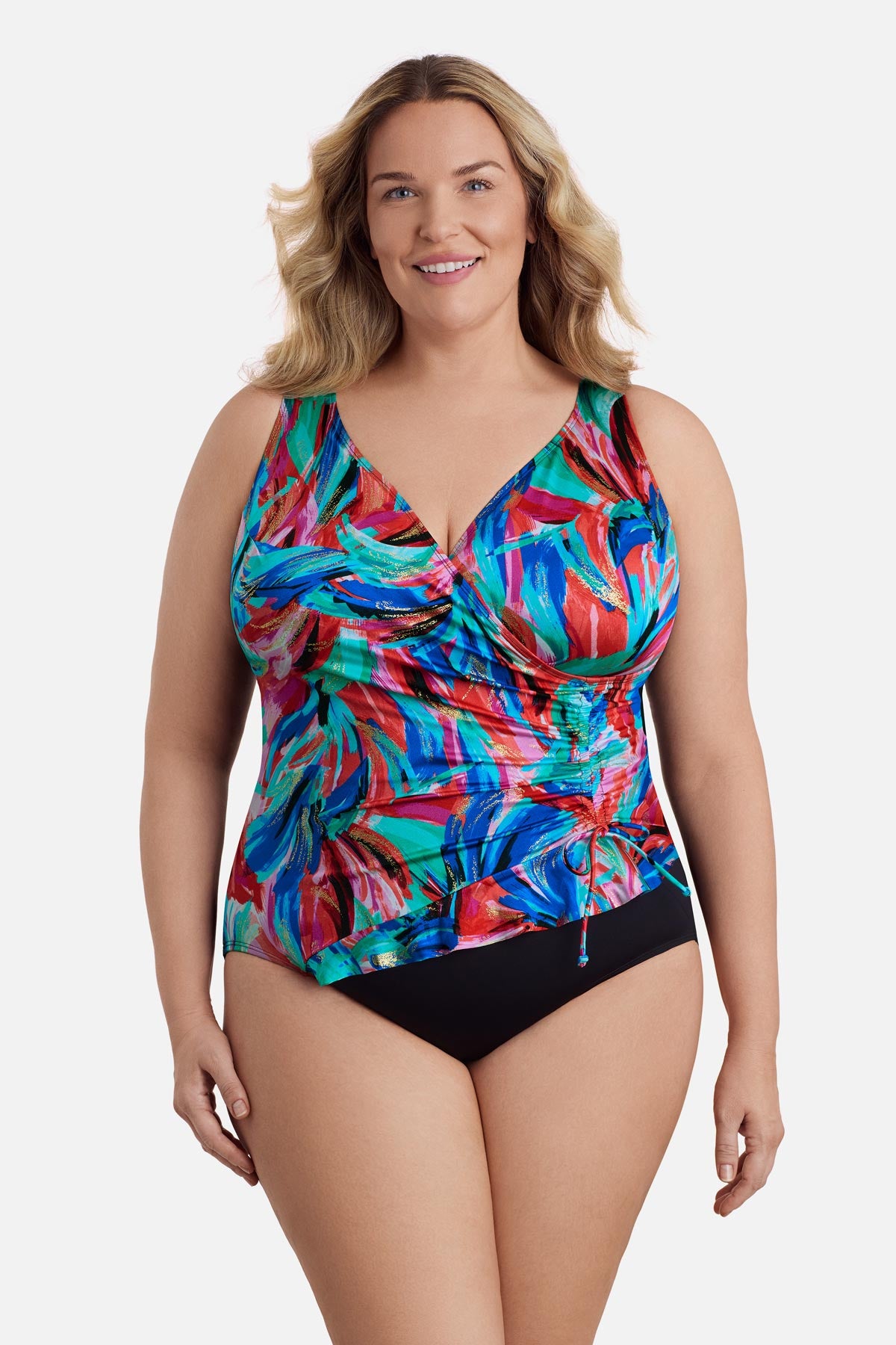 Woman wearing a multicolored abstract printed one-piece swimsuit with side tie