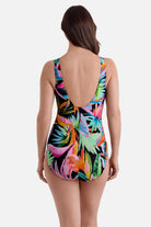 Woman faced away wearing a multicolor palm leaf printed one-piece swimsuit