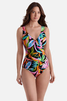 Woman wearing a multicolor palm leaf printed one-piece swimsuit