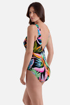 Woman turned left wearing a multicolor palm leaf printed one-piece swimsuit
