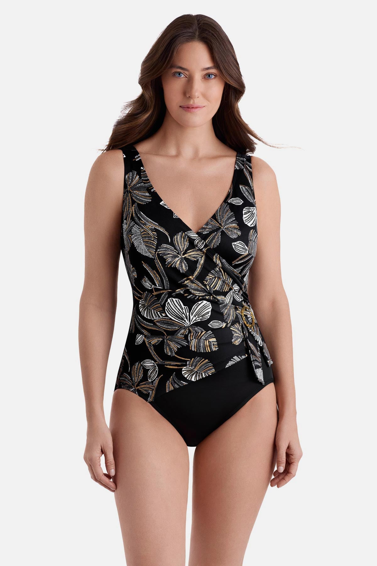 Woman wearing a white and gold floral pattern one piece with a v-neck