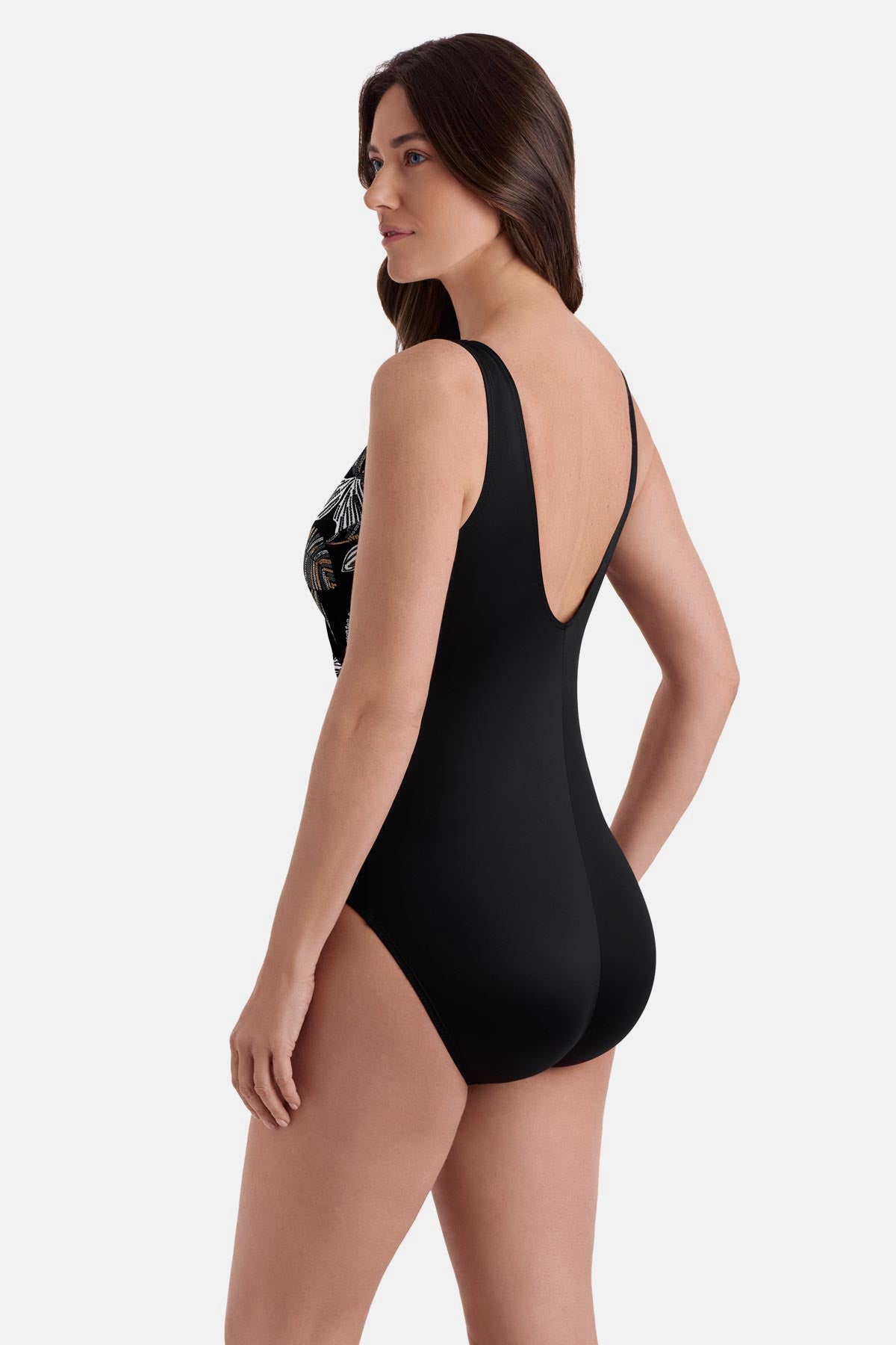 Woman turned left wearing a white and gold floral pattern one piece 