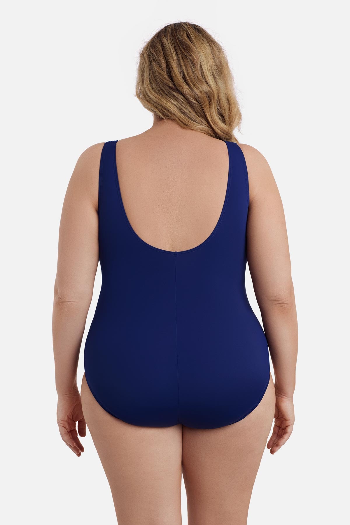 Woman faced away wearing a navy blue abstract printed one-piece swimsuit 