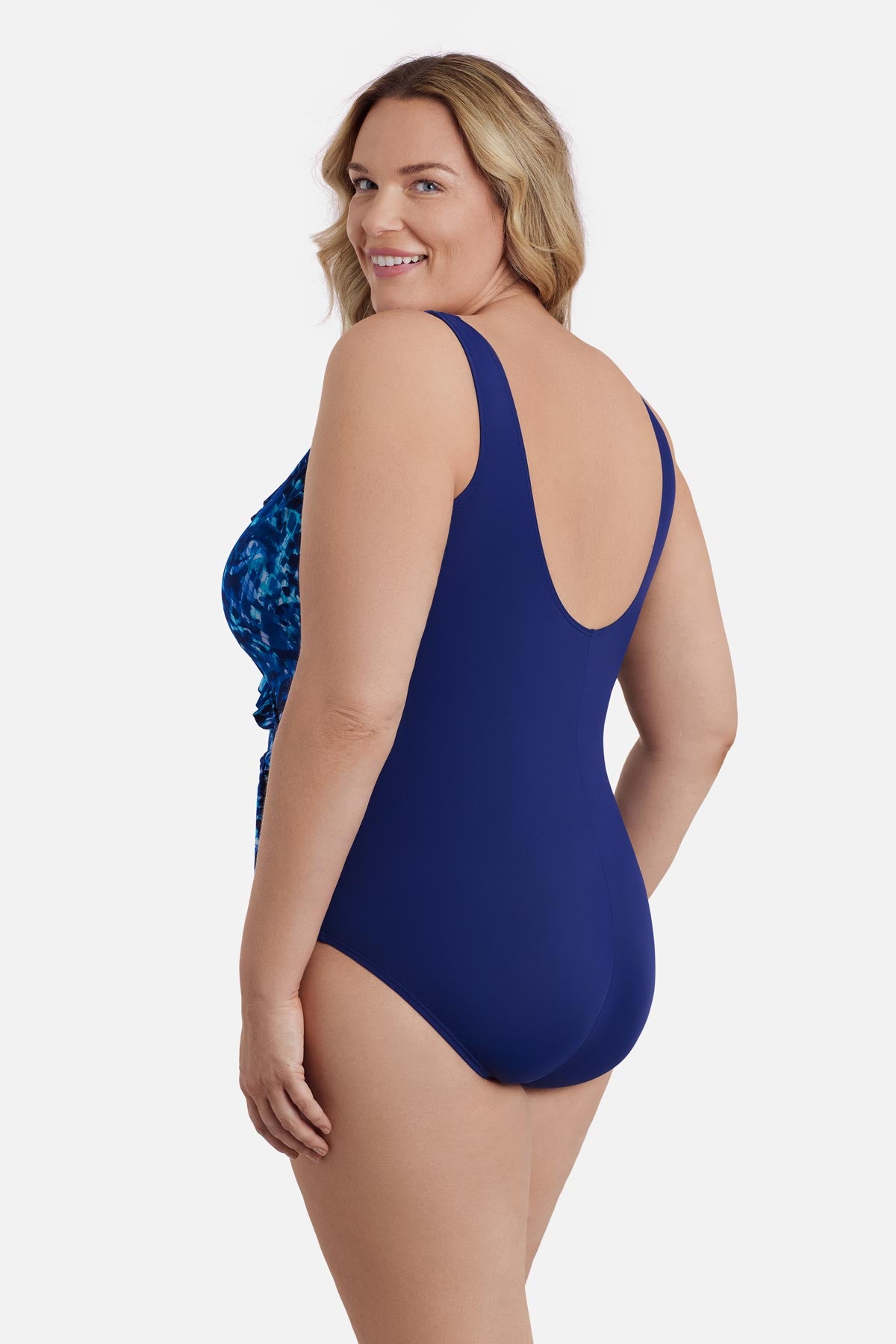 Woman turned left wearing a navy blue abstract printed one-piece swimsuit 