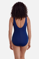 Woman faced away wearing a blue abstract printed one-piece swimsuit