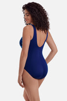 Woman faced left wearing a blue abstract printed one-piece swimsuit