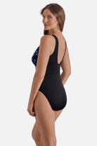 Woman faced left wearing a blue abstract printed one-piece swimsuit 