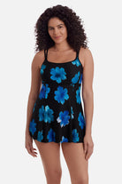 Woman wearing a black swim dress with large blue flowers