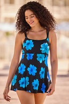Woman wearing a black swim dress with large blue flowers