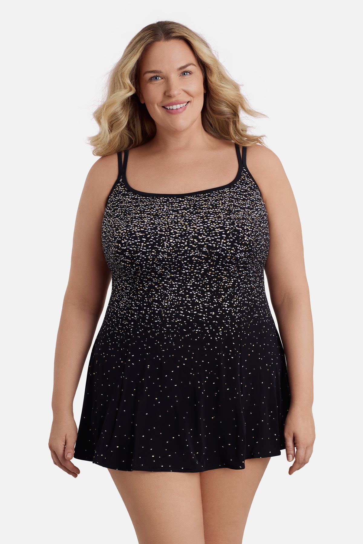 Woman wearing a black and white dot print swim dress