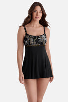 Woman wearing a swim dress with white and gold floral print on the bust