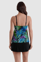 Woman turned away wearing a multicolor palm leaf print faux ruffle skirtini swimsuit
