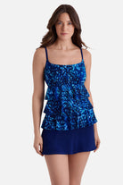 Woman wearing a blue abstract print ruffle skirtini swimsuit