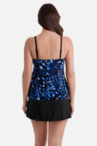 Woman turned away wearing a blue abstract printed faux ruffle skirtini swimsuit