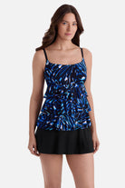 Woman wearing a blue abstract printed faux ruffle skirtini swimsuit
