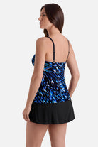 Woman turned left wearing a blue abstract printed faux ruffle skirtini swimsuit
