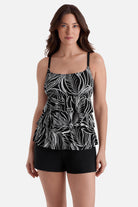 Woman wearing a black and white fern printed ruffle shortini swimsuit