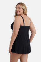 Woman turned left wearing a black swim dress with a v neckline