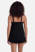 Woman turned away wearing a black swim dress 