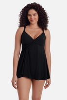 Woman wearing a black swim dress with a v neckline