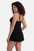 Woman turned left wearing a black swim dress with a v neckline