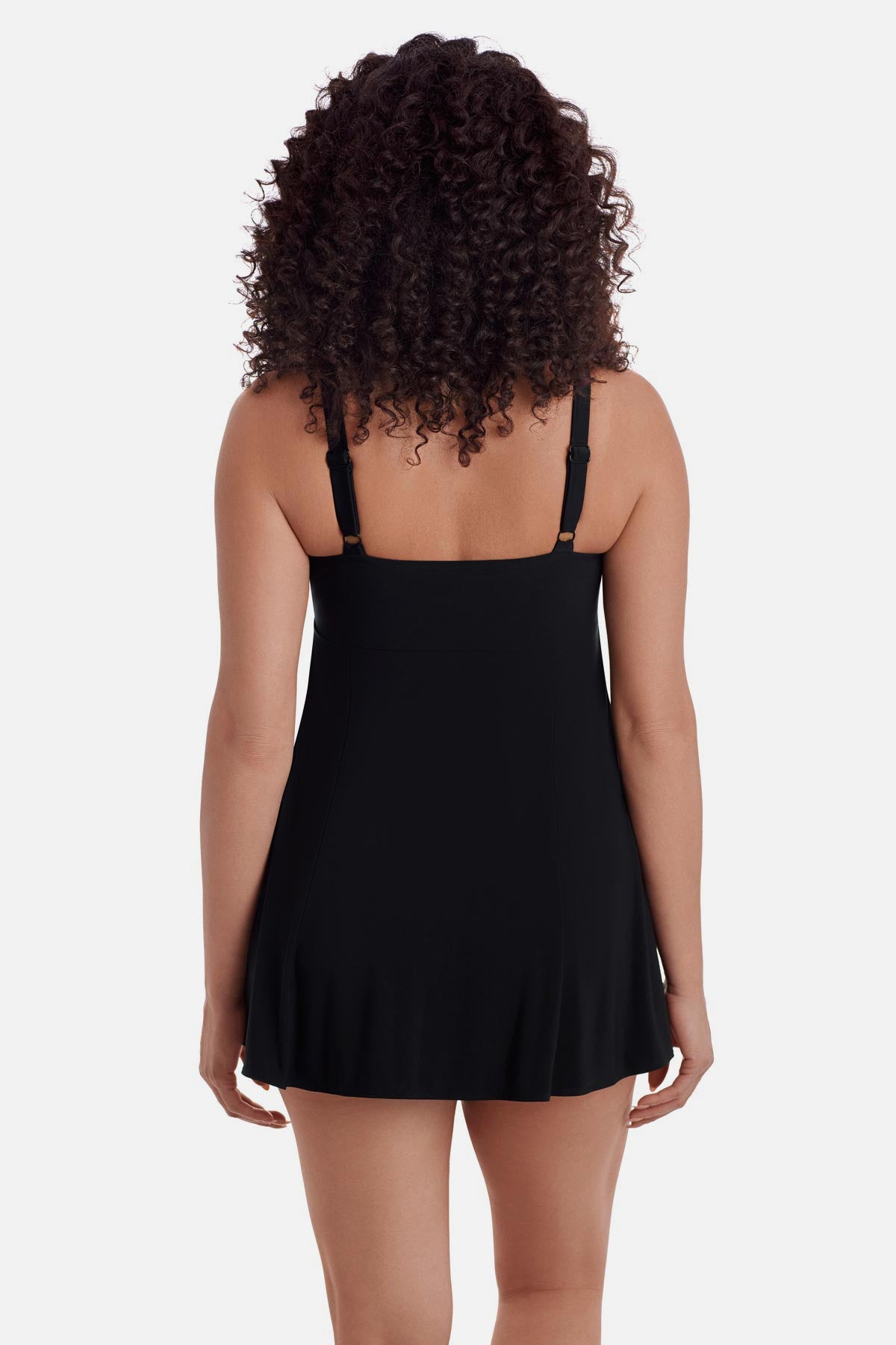 Woman turned away wearing a black swim dress 