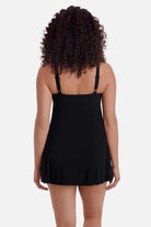 Woman turned away wearing a black swim dress 