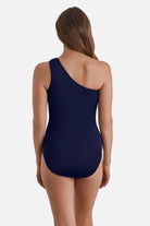 Woman turned away wearing a blue and white abstract floral printed one shoulder one-piece swimsuit
