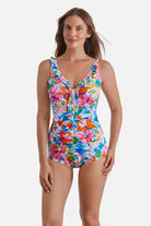 Woman wearing a multicolor floral printed one-piece swimsuit with ruffles down the front