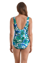 Woman turned away wearing a blue and green floral printed square neck one-piece swimsuit