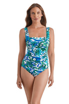 Woman wearing a blue and green floral printed square neck one-piece swimsuit