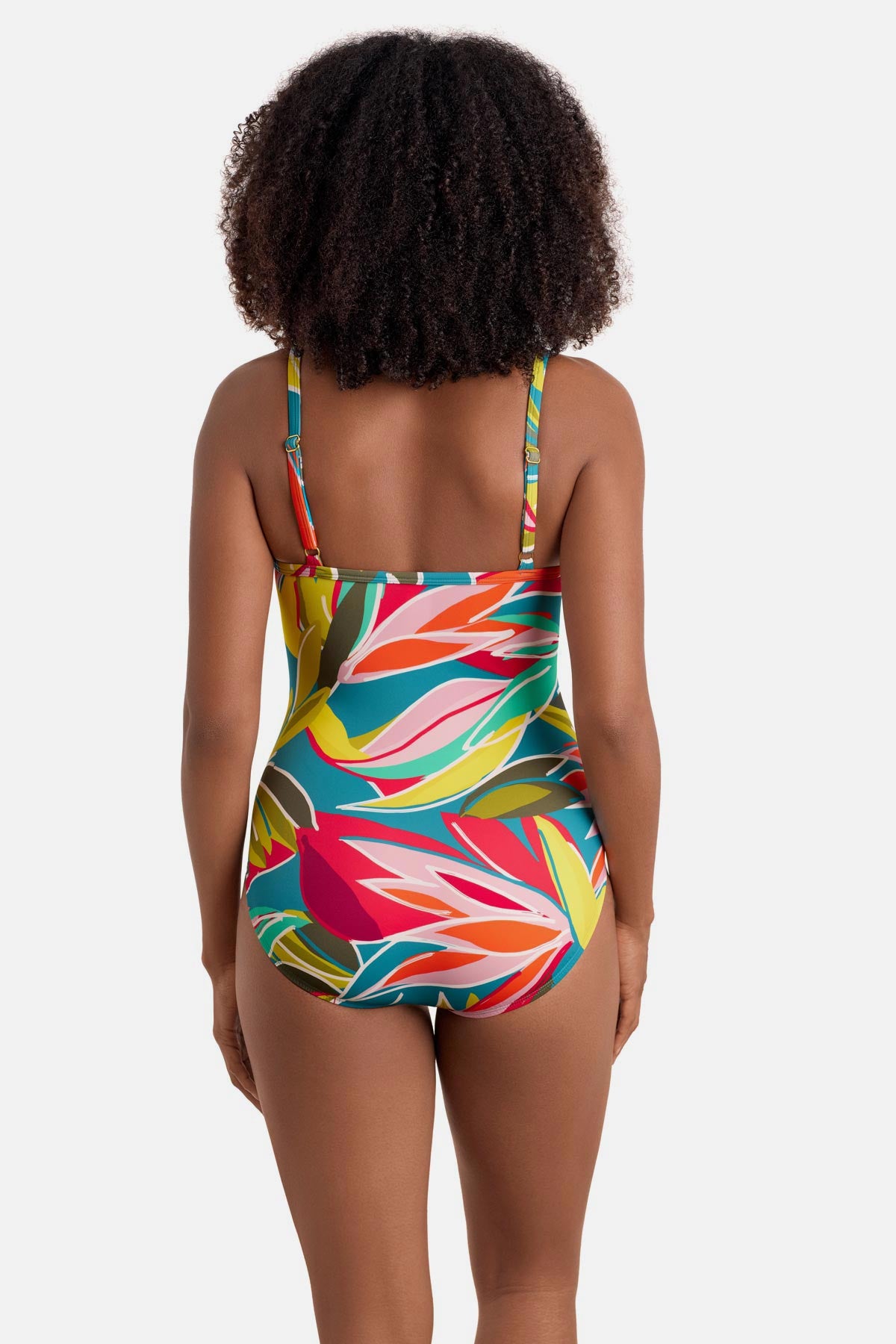 Woman turned away wearing a multicolored abstract printed one-piece swimsuit