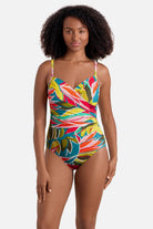 Woman wearing a multicolored abstract printed one-piece swimsuit