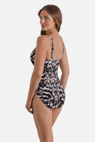 Woman turned left wearing an animal skin printed one-piece swimsuit
