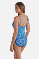 Woman turned left wearing a blue tile print one-piece swimsuit