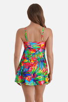 Woman turned away wearing a multicolor palm leaf printed swim dress 